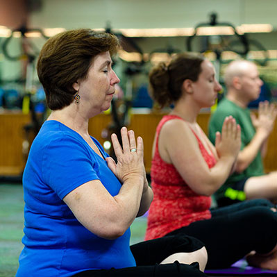 Women participating in a yoga class. Links to Under Age 60 