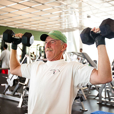 A man lifting weights. Links to Ages 60–70 